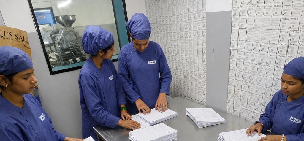 Female workers handling documents on the pharmaceutical manufacturing floor